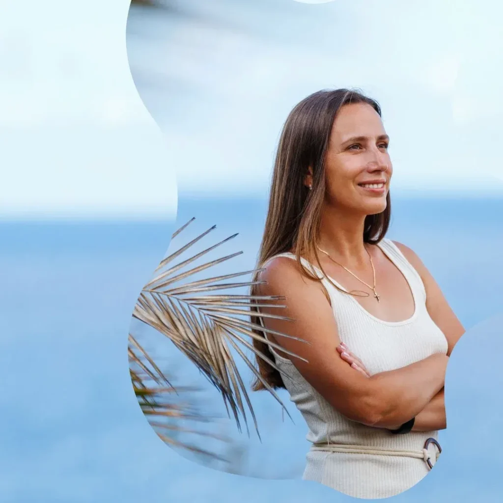Happy woman smiling by the ocean after a relaxing massage session for better health.